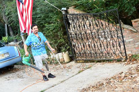 J. Carmen Arevalo is glad that his prosthesis allows him to stay active and do things like work in the yard at his home in Pearl.