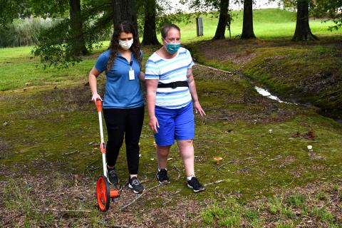 Molli Sorrels, left, a physical therapist with Methodist Outpatient Therapy in Flowood, monitors Juliette Collier’s progress as she navigates uneven ground. Improving her balance and fine-tuning her walking skills has been a major focus of Collier’s therapy.