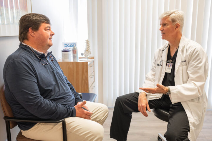 Doctor speaking with a patient in a patient room