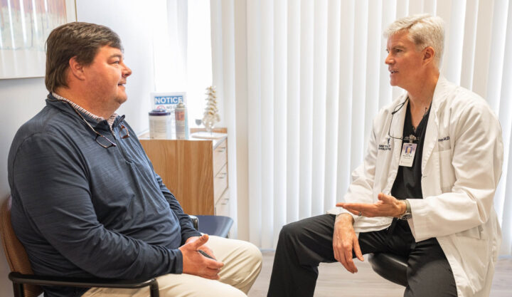 Doctor speaking with a patient in a patient room