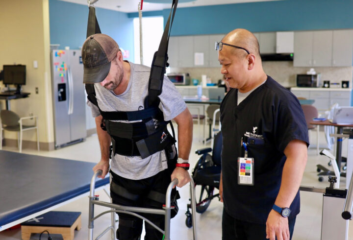Patient walking with support of a therapist