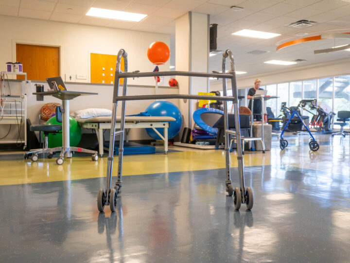 Interior of a therapy gym with a walker front and center