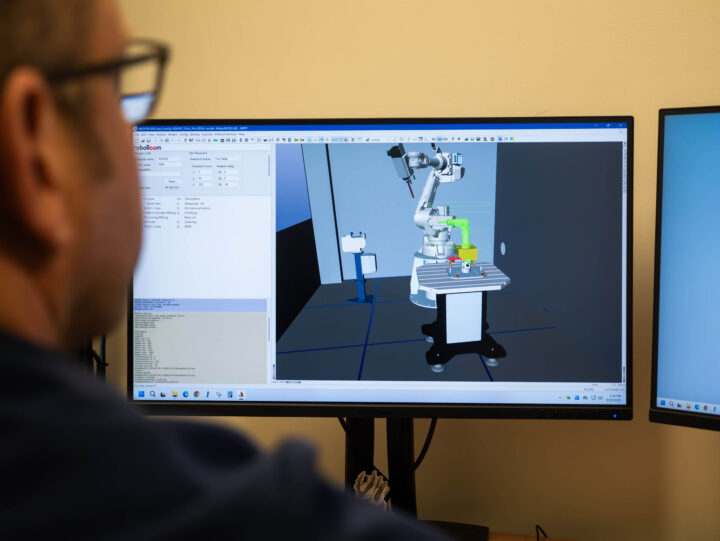 Researcher looking at a CAD rendering on a computer monitor