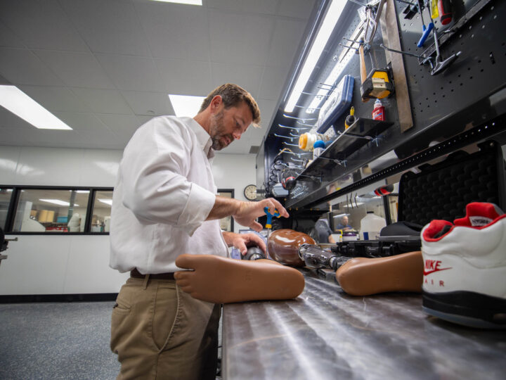 Team member from our Orthotics and Prosthetics team tightening a screw on a custom prosthetic
