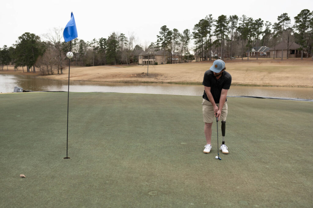 Josh Brown playing golf with his leg prosthetic