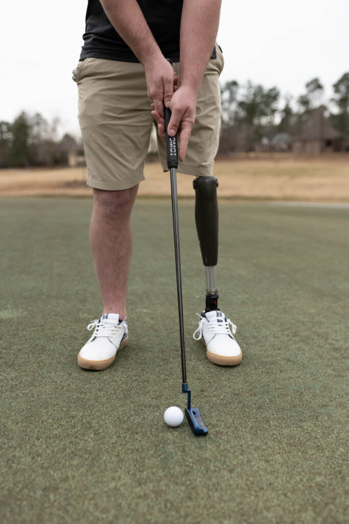 Close up of Josh Brown playing golf with his leg prosthetic