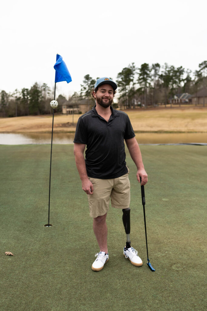 Portrait of Josh Brown on a golf course with his leg prosthetic