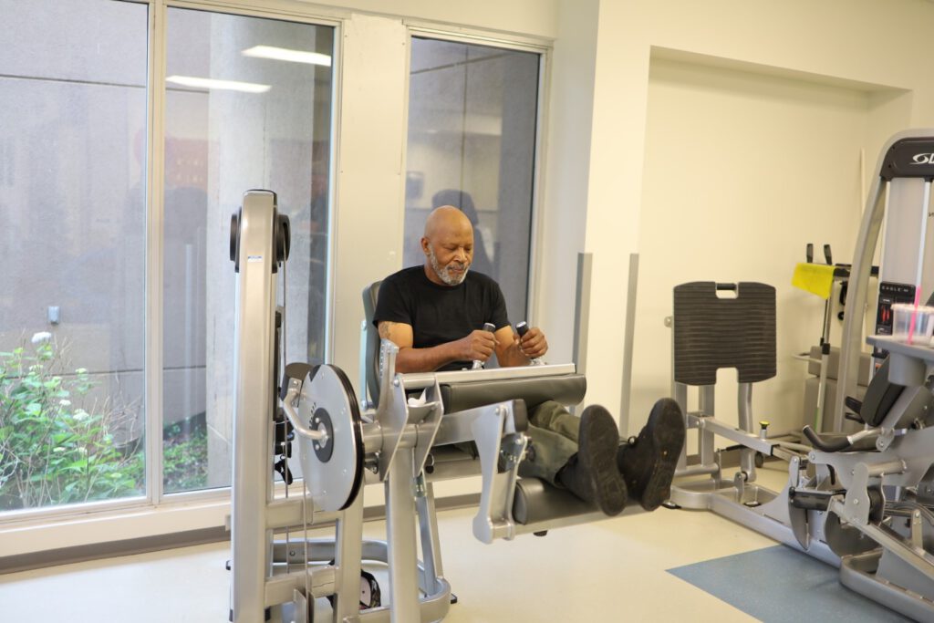 Patient Michael Johnson doing an leg extension workout