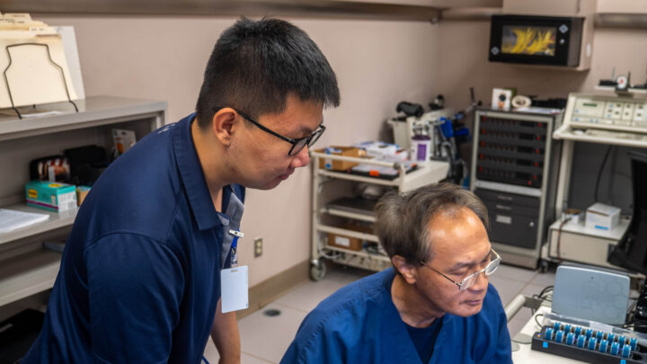 Two researchers collaborating and looking at a computer monitor