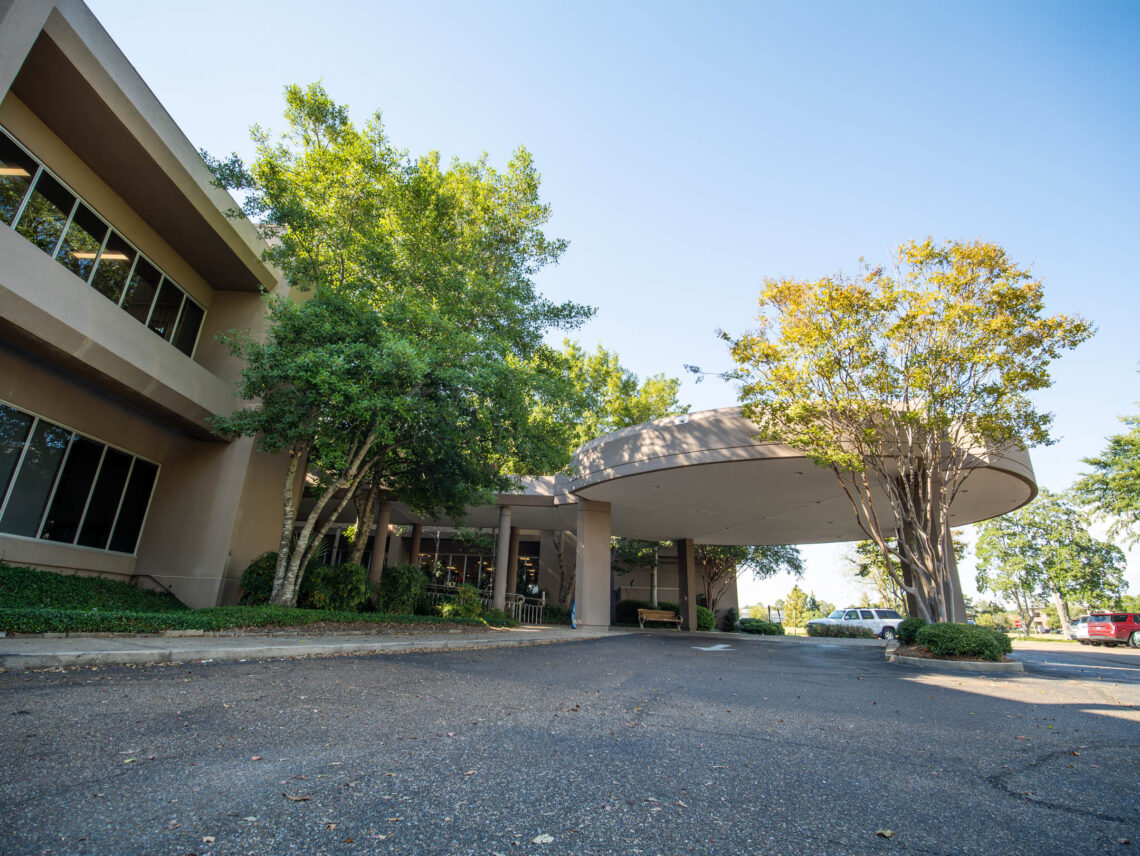 Exterior photo of our Flowood location and the entrance for Physical Medicine, Outpatient Therapy, and Pain Management