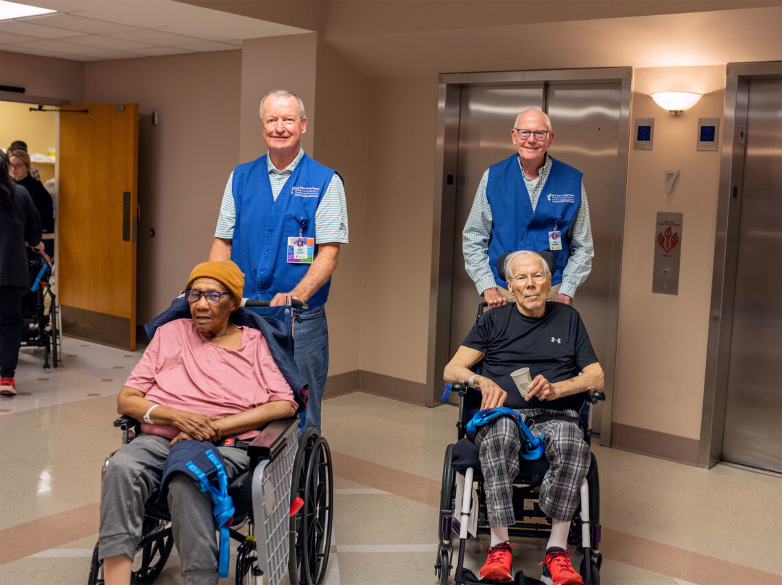 Members of the Methodist Foundation pushing individuals in wheel chairs