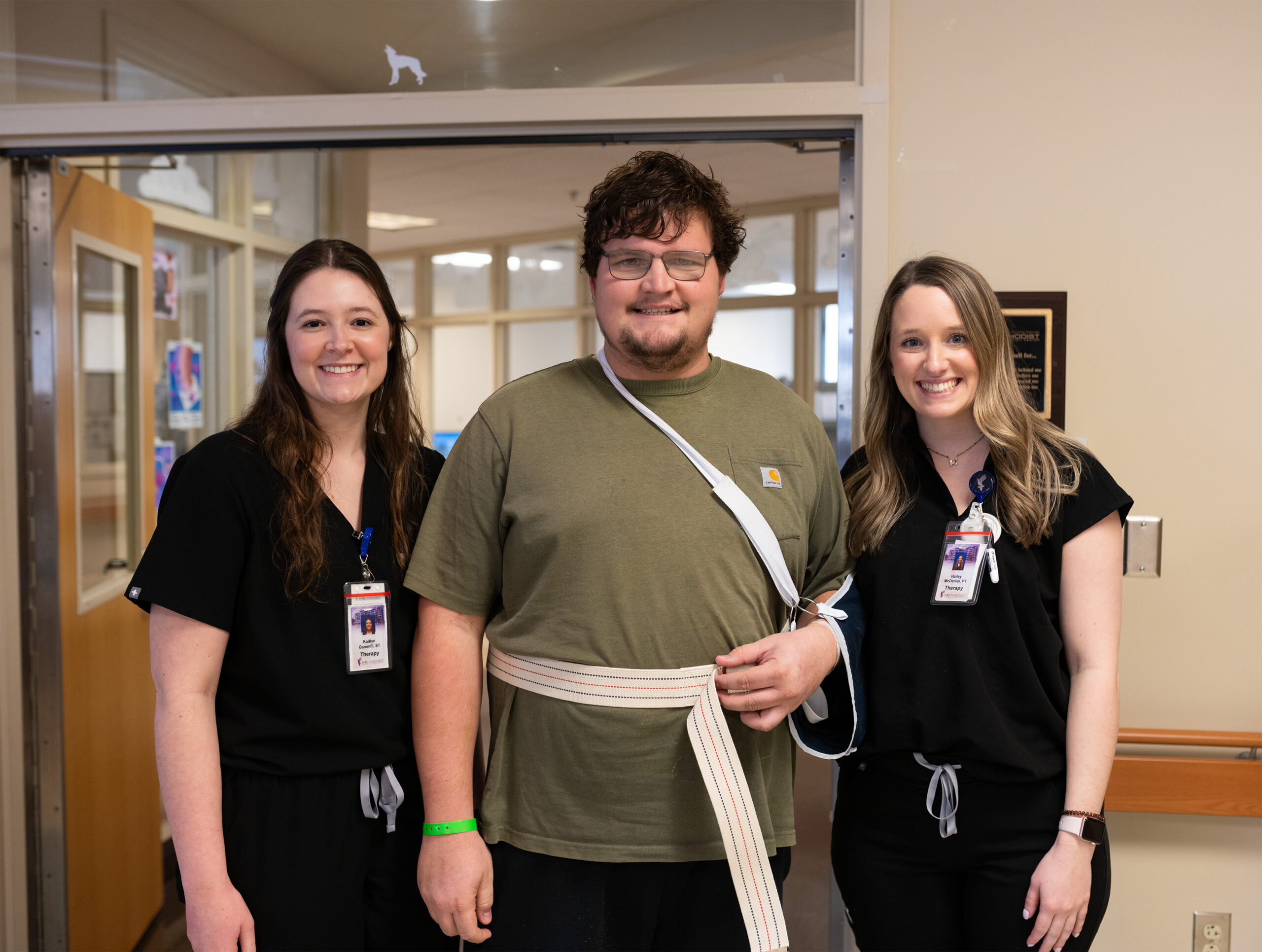 Patient and two therapists posing for a photo