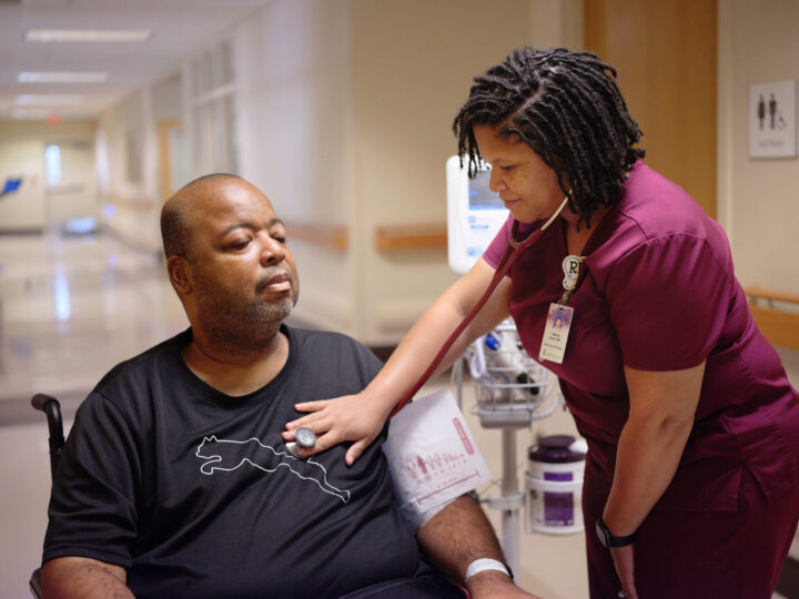 Nurse checking the heart rate of a patient