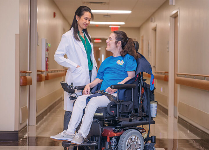 Doctor Villa Corta with patient seated in a wheel chair