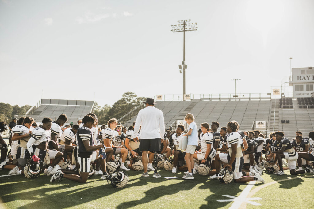 Coach Schoolar and football team